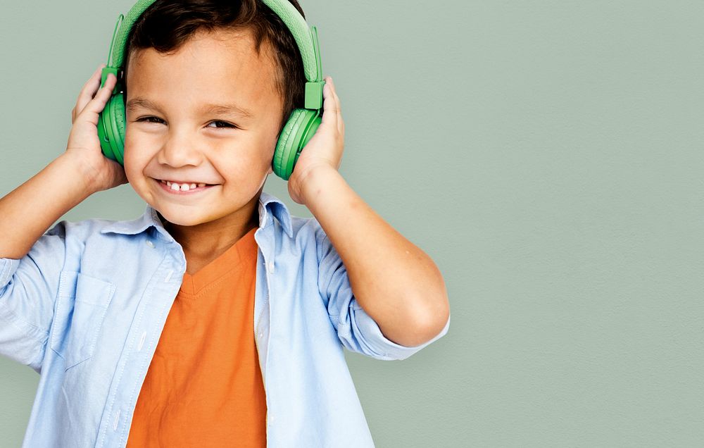 Young asian boy wearing headphones listening to music