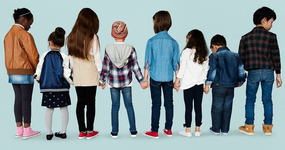 Group of diverse kids students standing in a row holdings hands