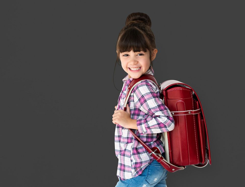 Young asian kid student with a backpack studio portrait
