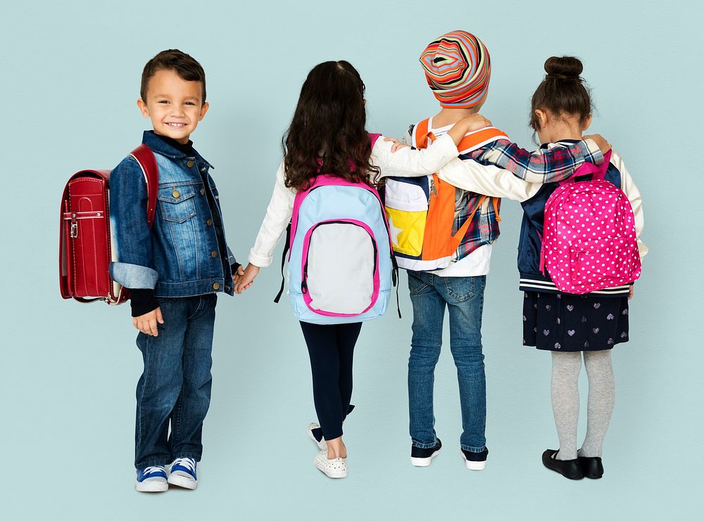 Rear view group of diverse kids wearing backpack