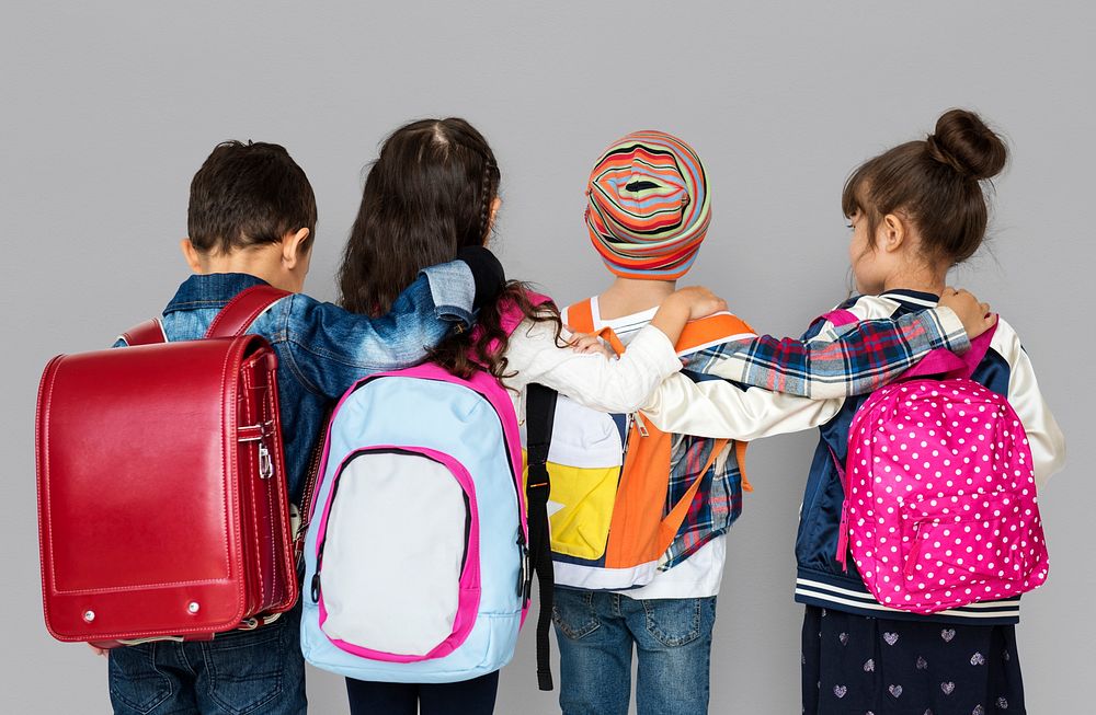 Rear view group of diverse kids wearing backpack