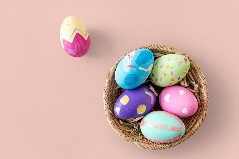 A variety easter painted eggs is in bucket.