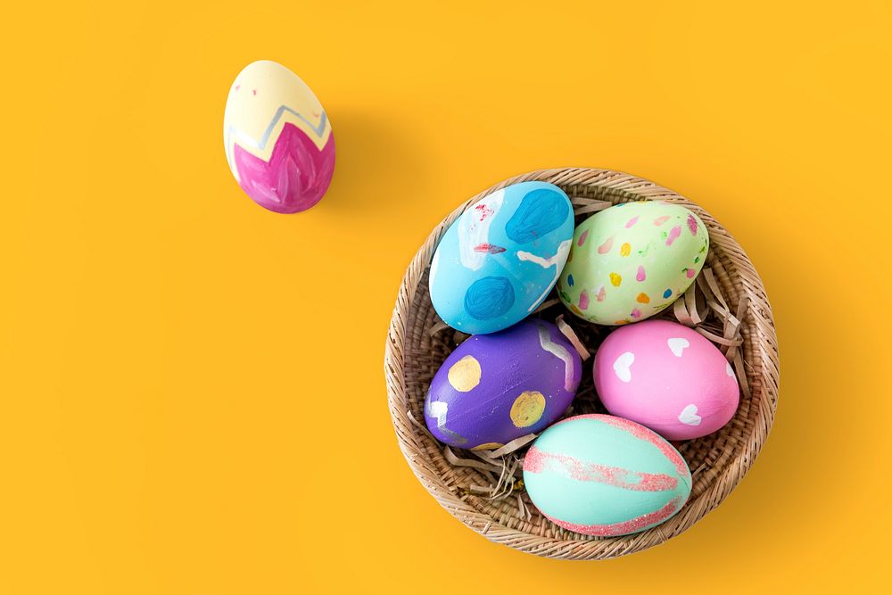 A variety easter painted eggs is in bucket.