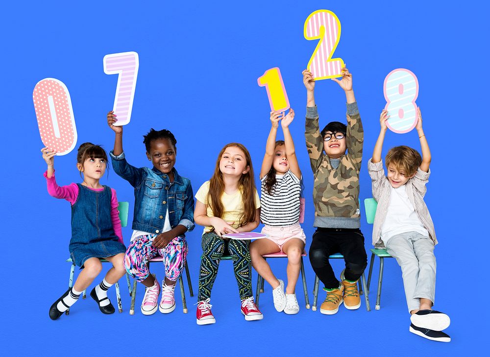 A group of children are holding a number