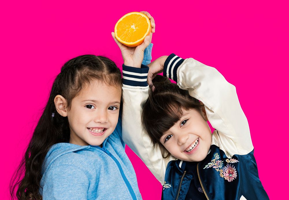 Two girls and fresh orange
