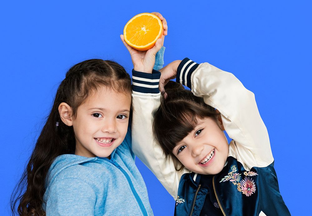 Two girls and fresh orange