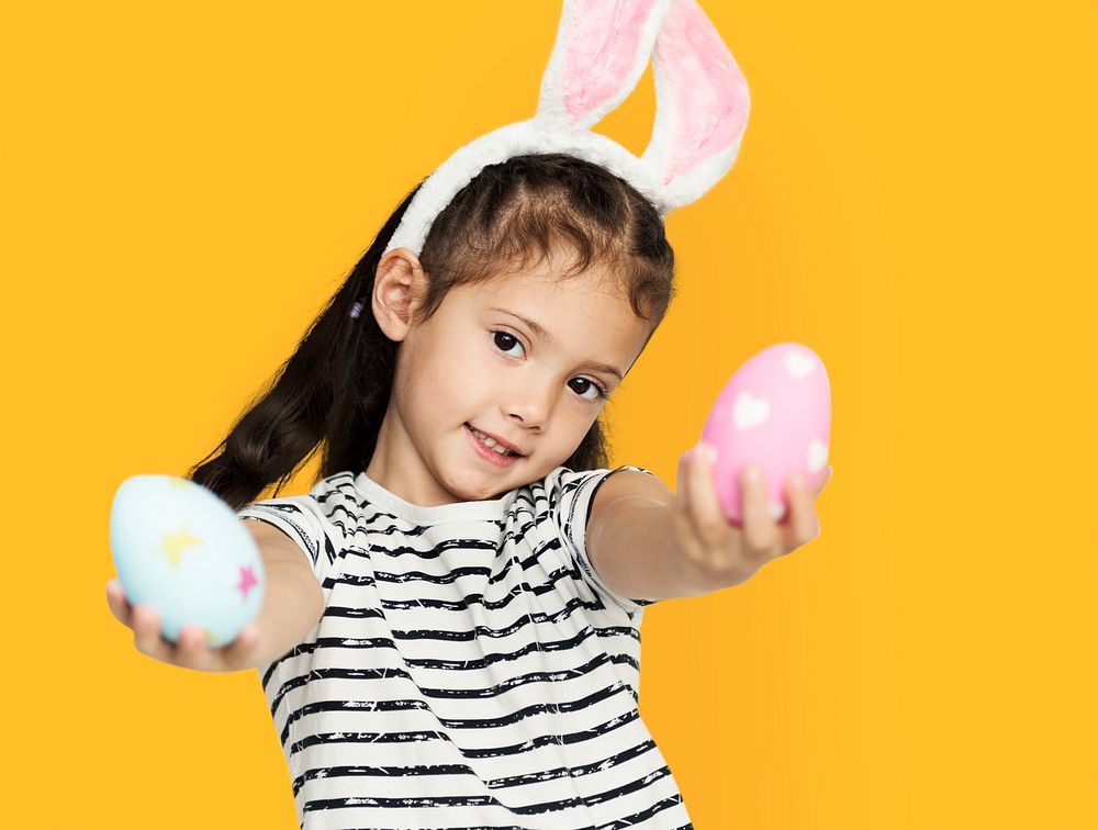 A girl with an easter eggs and bunny hairband