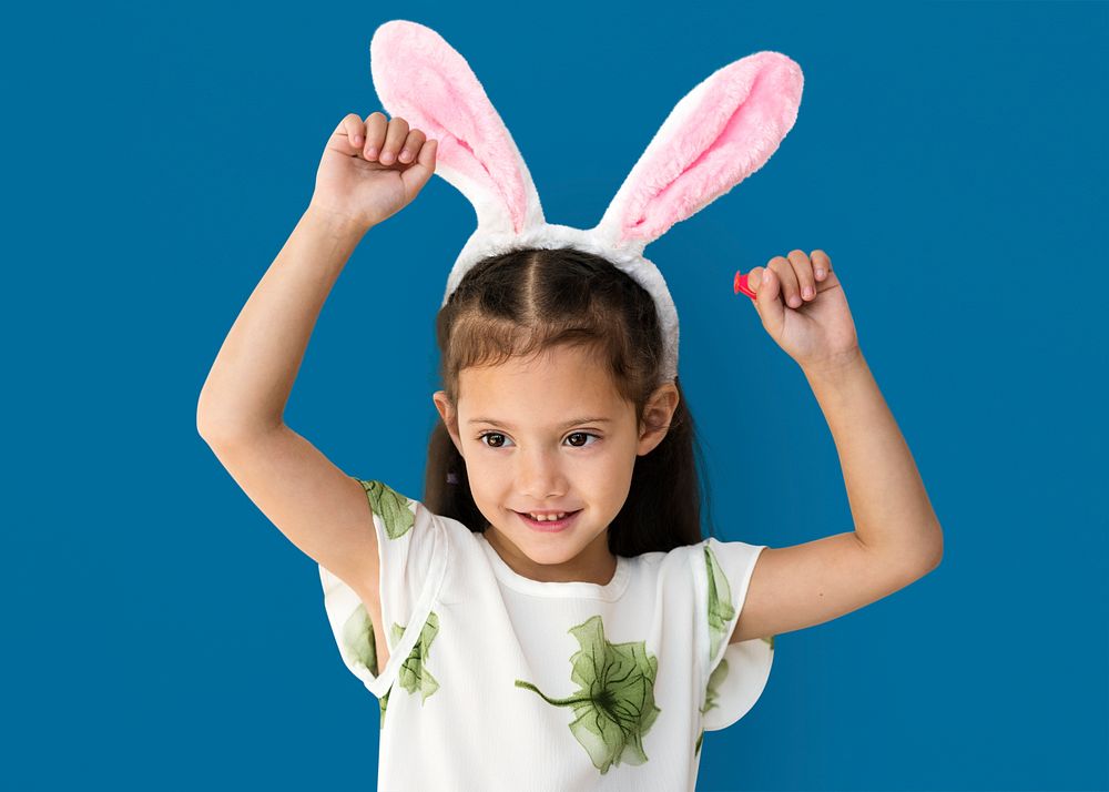 A caucasian girl with a bunny hairband.