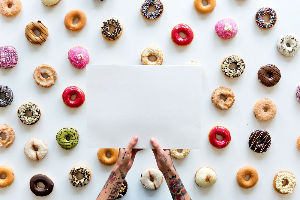 People Hands Hold Paper with Doughnuts Background