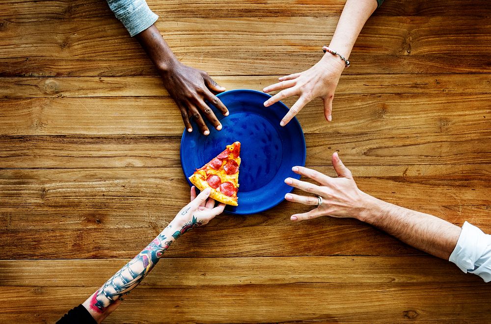 Hands Trying to get Last Piece of Pizza