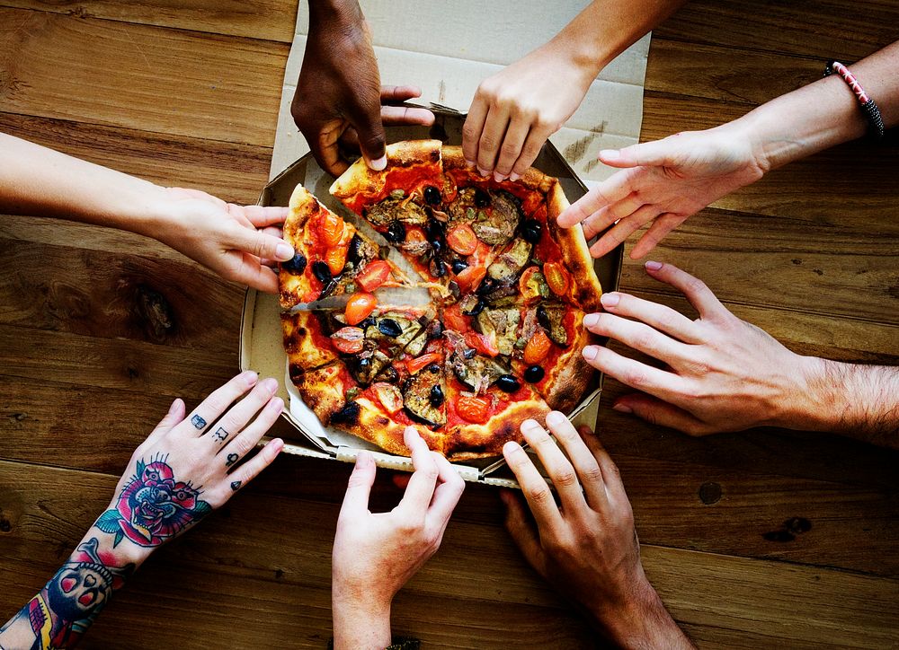 People Hands Grabbing Slice of Pizza