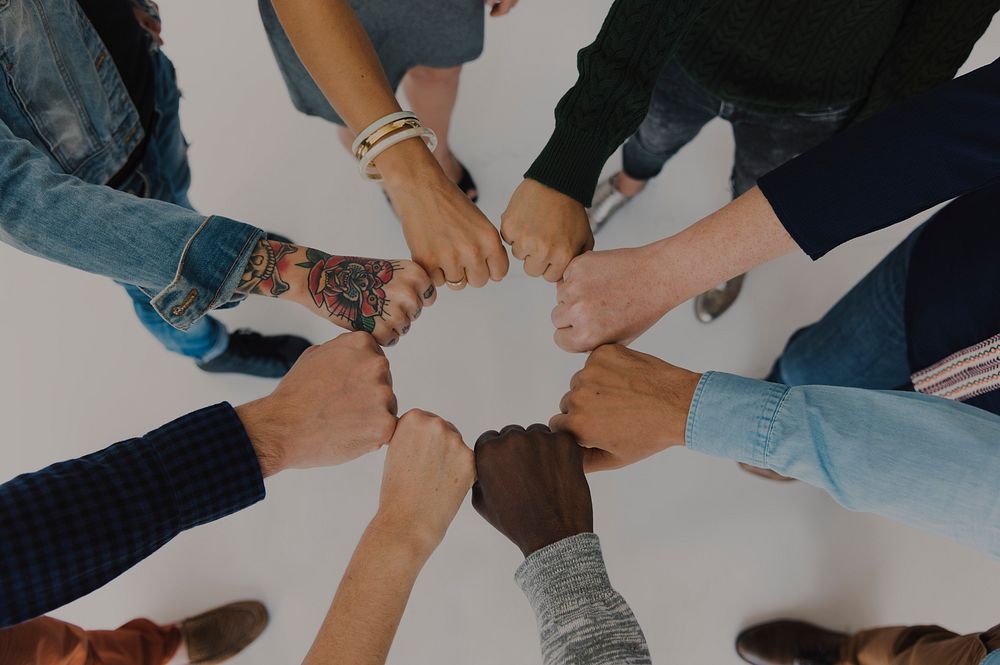 Diverse People Hands Fists Together Partnership