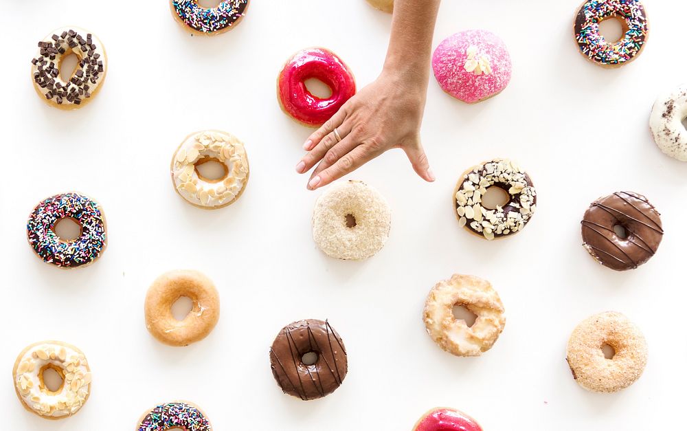 People Hands Reach for Doughnuts