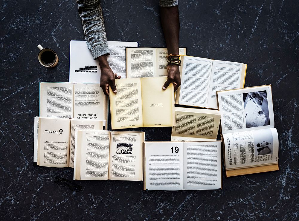 Human hand holding and reading book for research