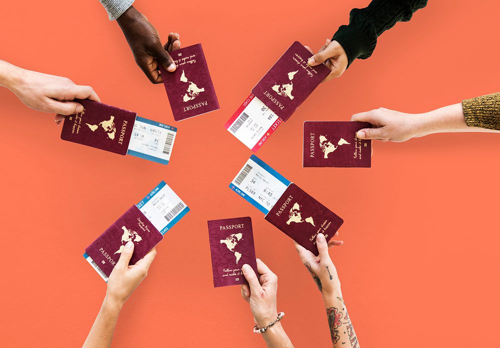 Group of hands holding passport in aerial view