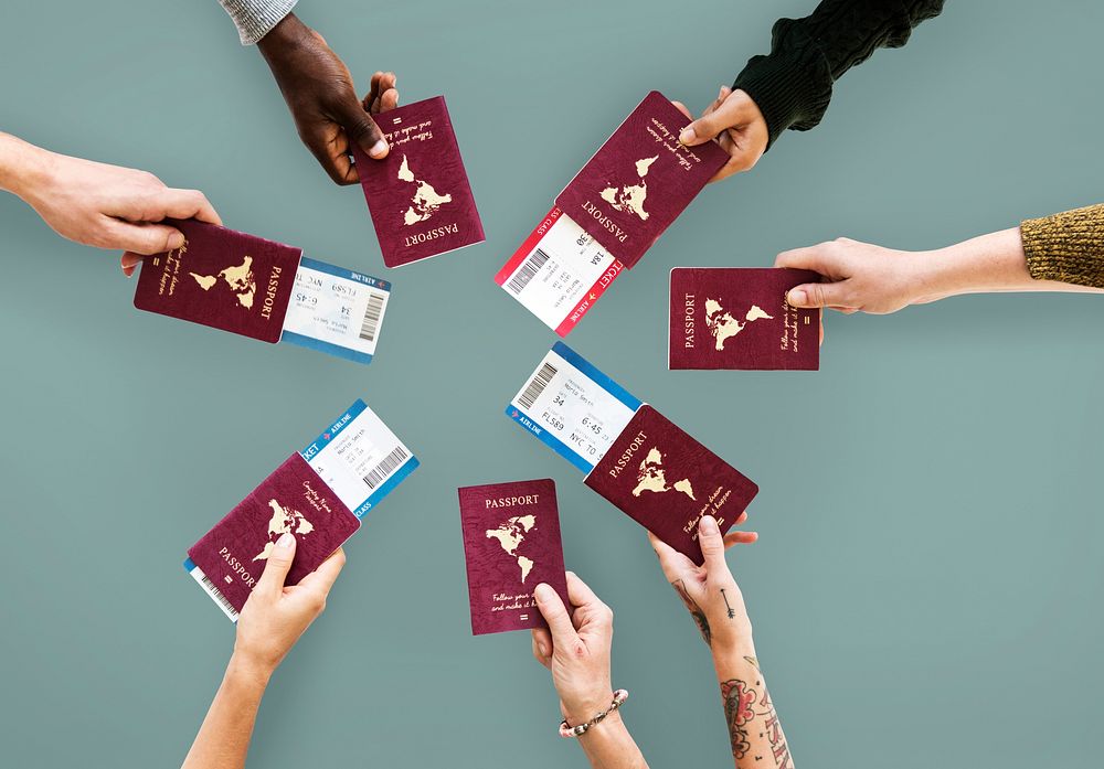 Group of hands holding passport in aerial view