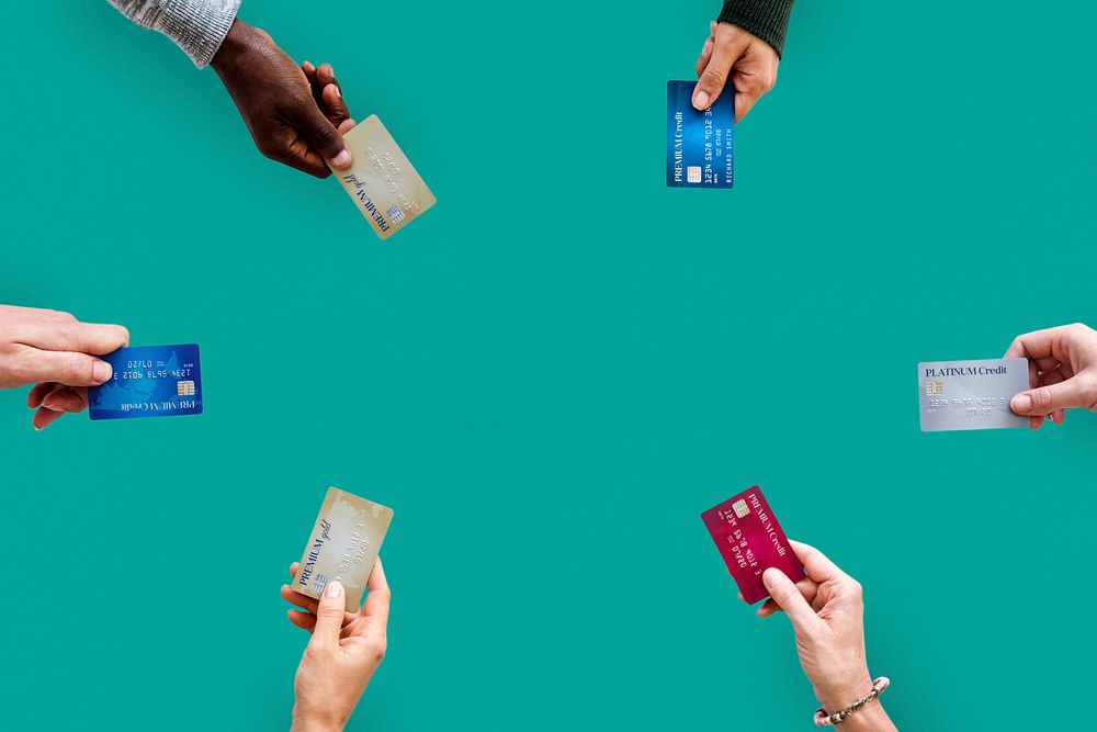 Group of hands holding credit card convenience life with copy space in aerial view