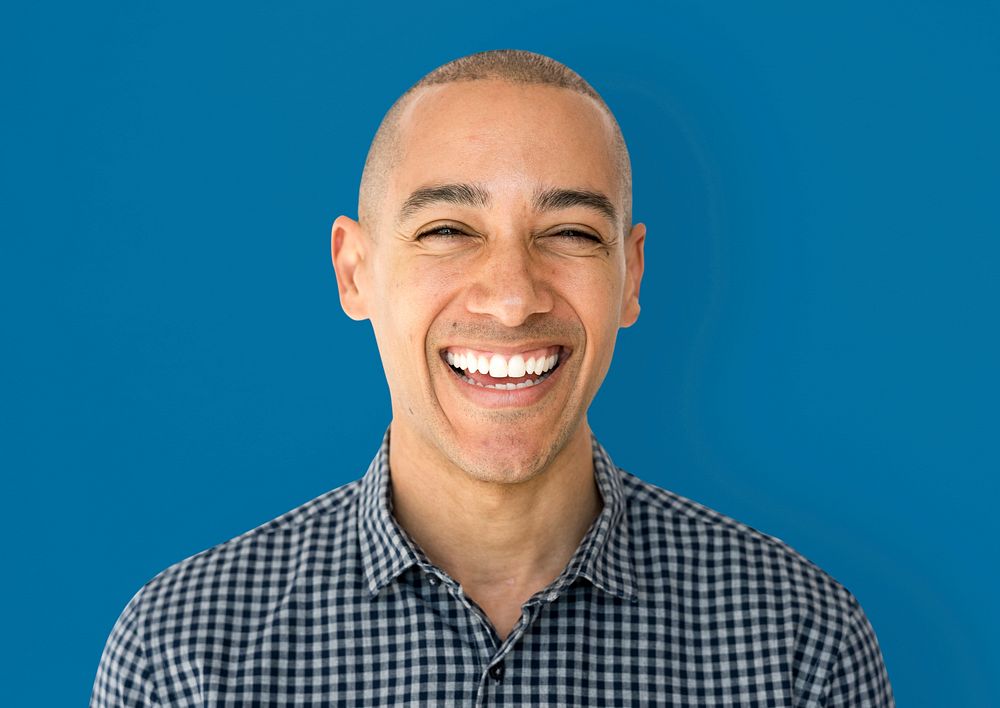 Skinhead man wearing checkered shirt studio shoot and smiling