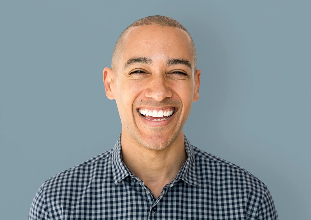 Skinhead man wearing checkered shirt studio shoot and smiling
