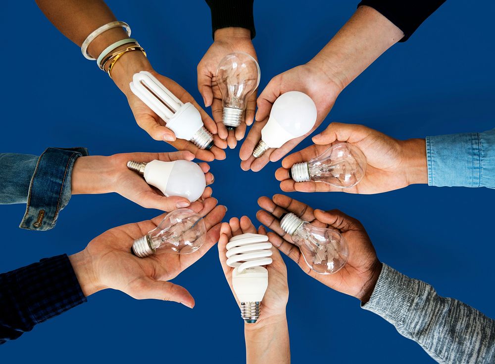 Diversity hands holding innovation lightbulb energy