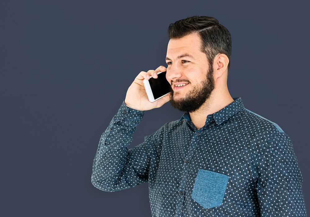 Man standing and using phone to pose for photoshoot