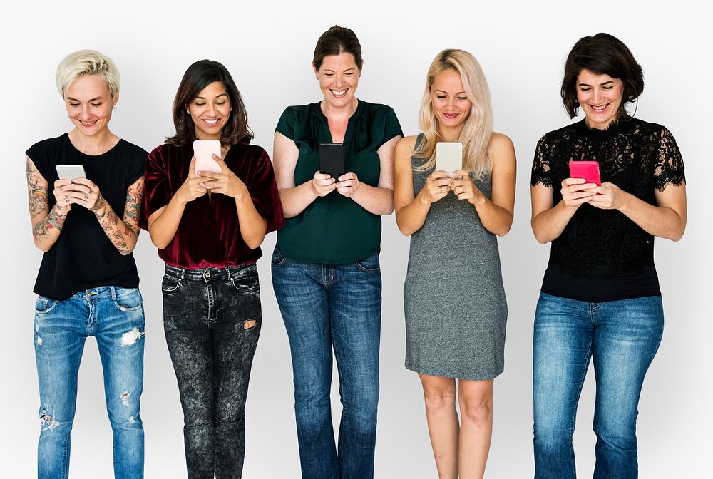 Happiness group of girlfriends smiling and conneted by mobile phone