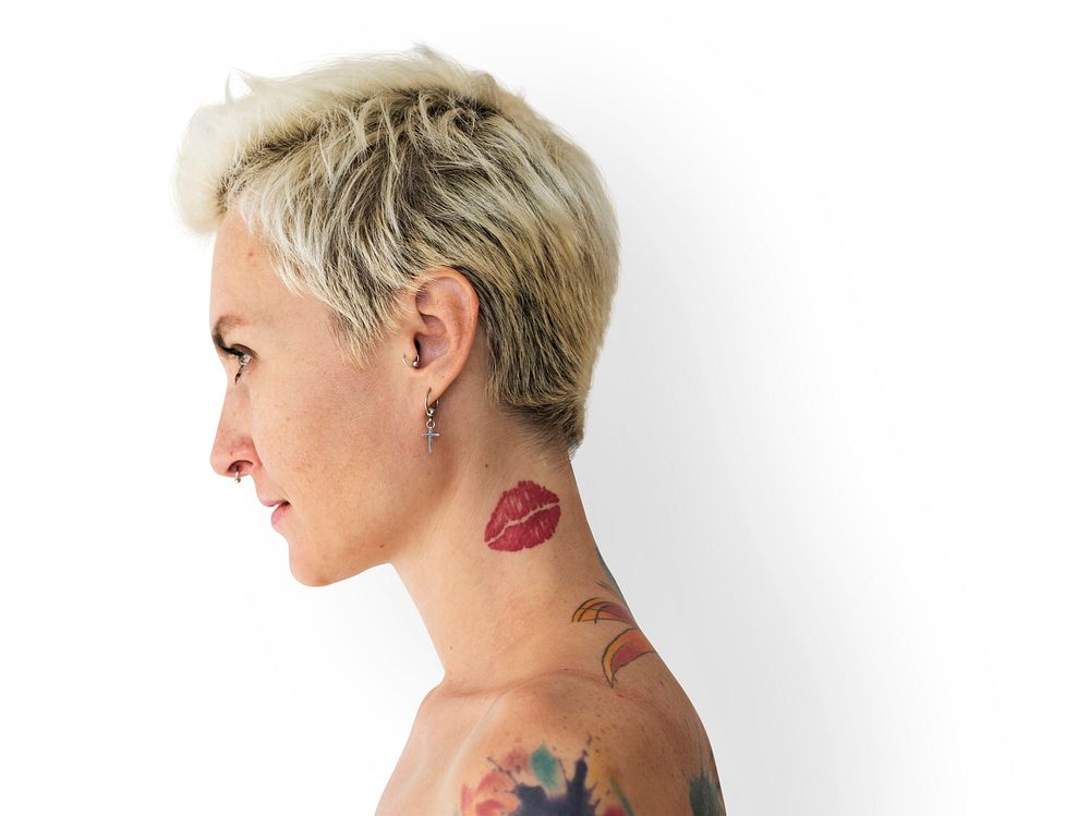 Profile portrait of a blonde woman with tattoos