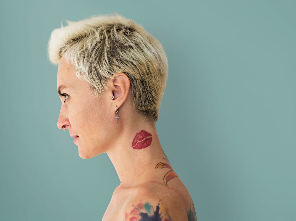Profile portrait of a blonde woman with tattoos