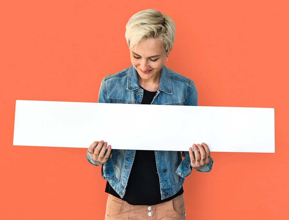 Portrait of a woman holding a blank signage