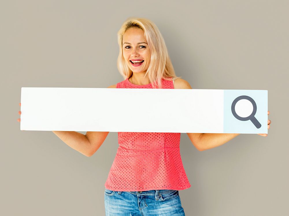 Woman holding paper search bar and smiling