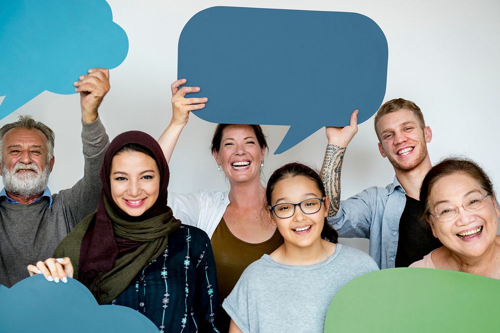 Diverse people holding a speech bubble
