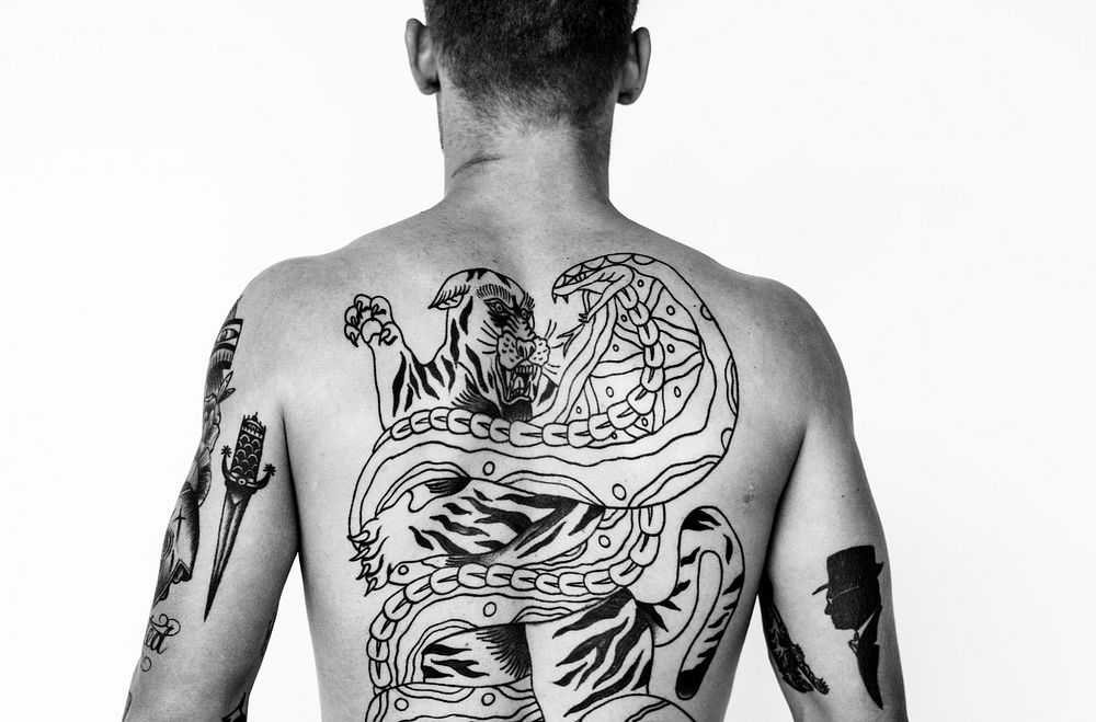 Rear view of a man with tattoo on his back