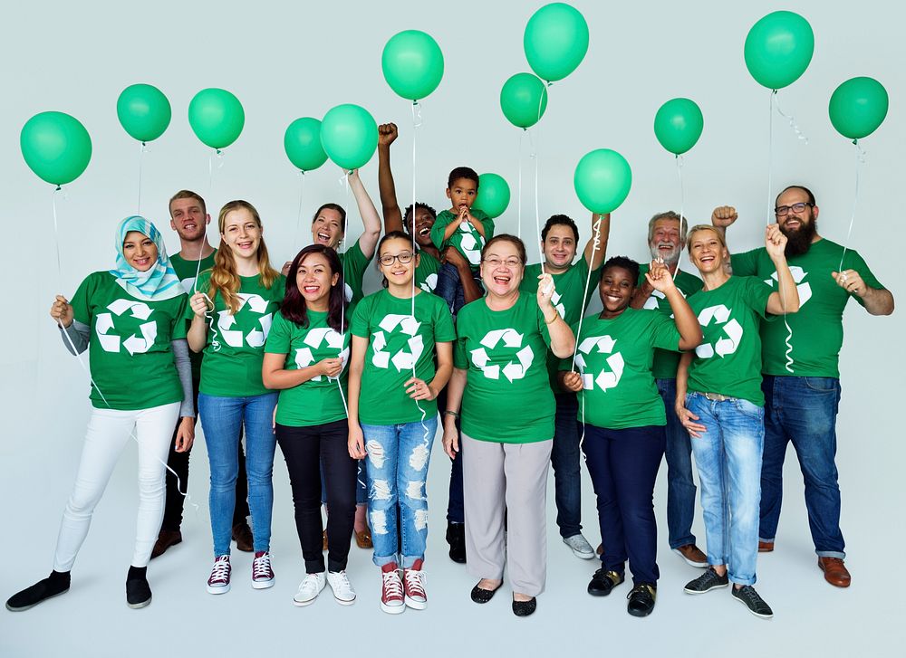 Ecology group of people smiling and holding balloons