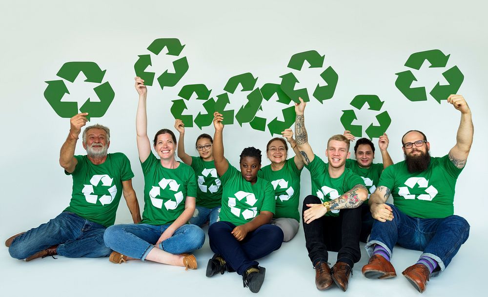 Ecology group of people smiling and holding recycle symbol