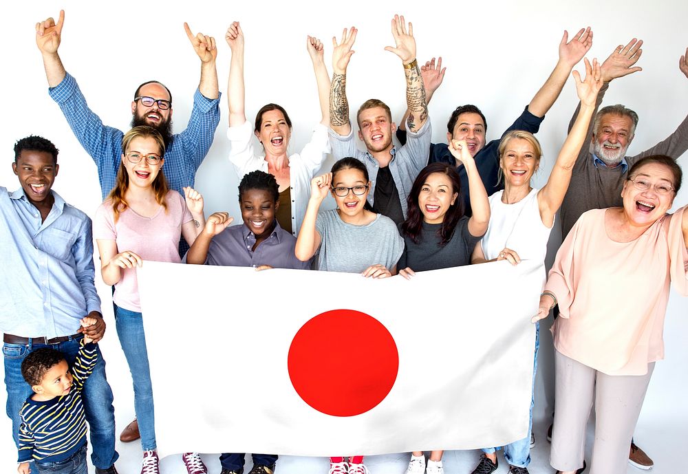 Group of people holding japanese flag studio portrait