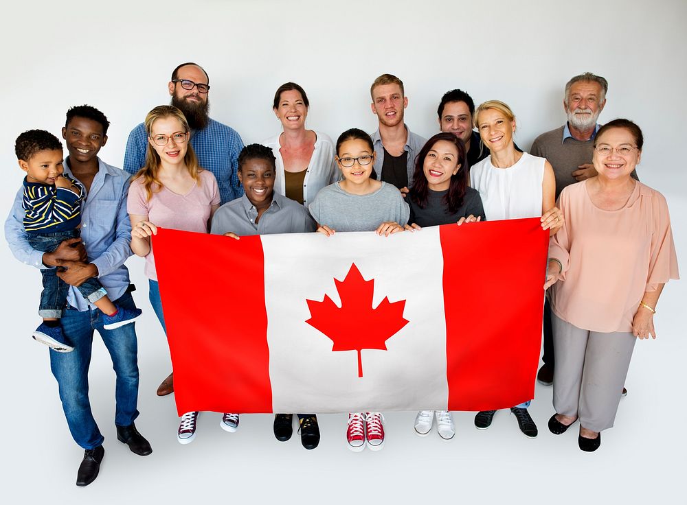 People in group holding country flag and posing for photoshoot