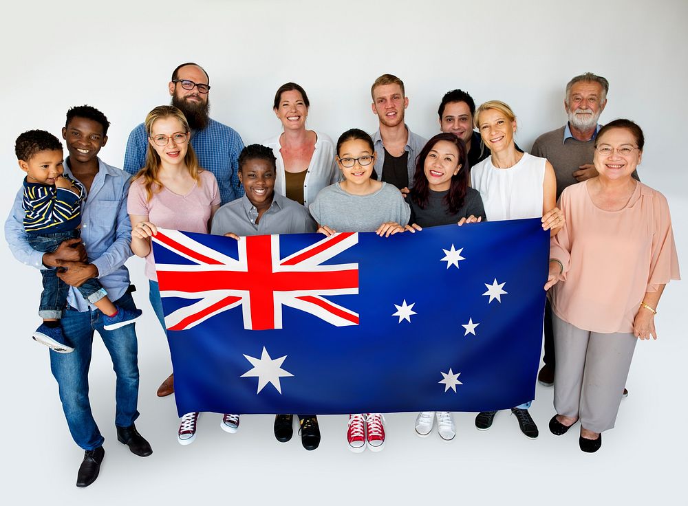 People in group holding country flag and posing for photoshoot