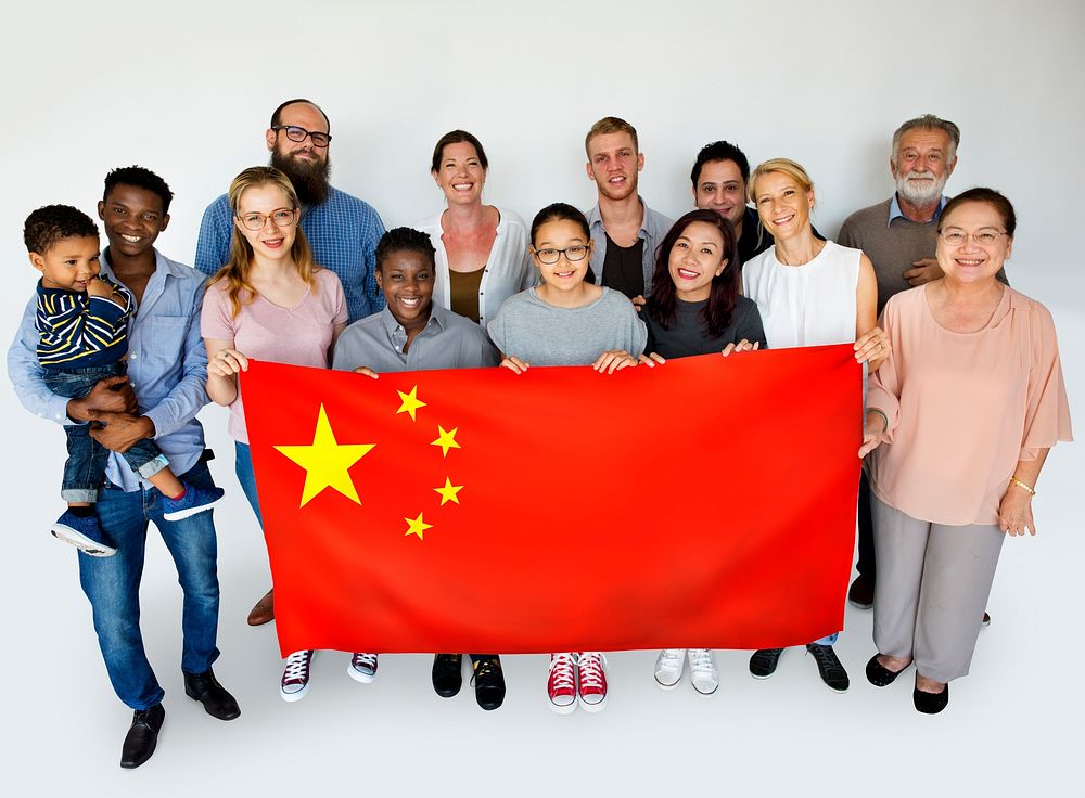 Group of people holding chinese flag studio portrait