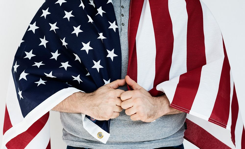 Man covering his shoulder with American flag