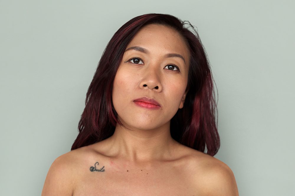 Asian woman bare chest topless studio portrait