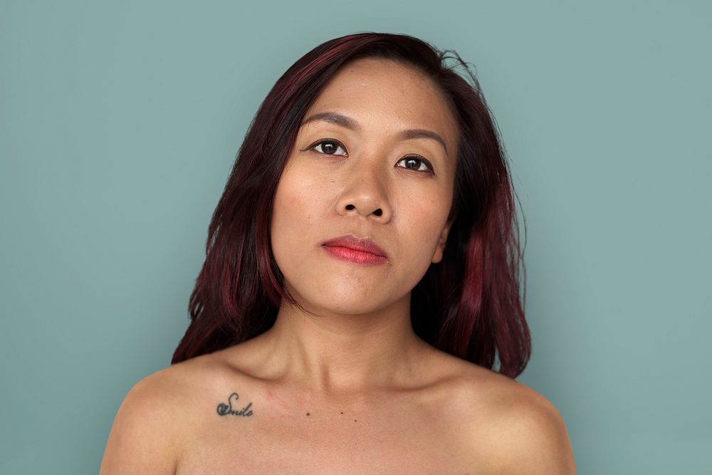 Asian woman bare chest topless studio portrait