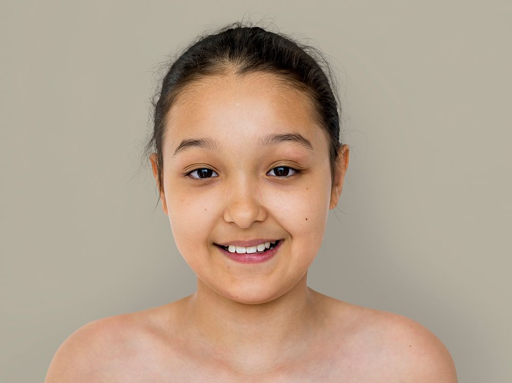 Little girl smiling bare chest studio portrait