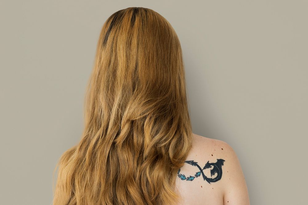 Young Adult Woman Back with Tattoo Studio Portrait