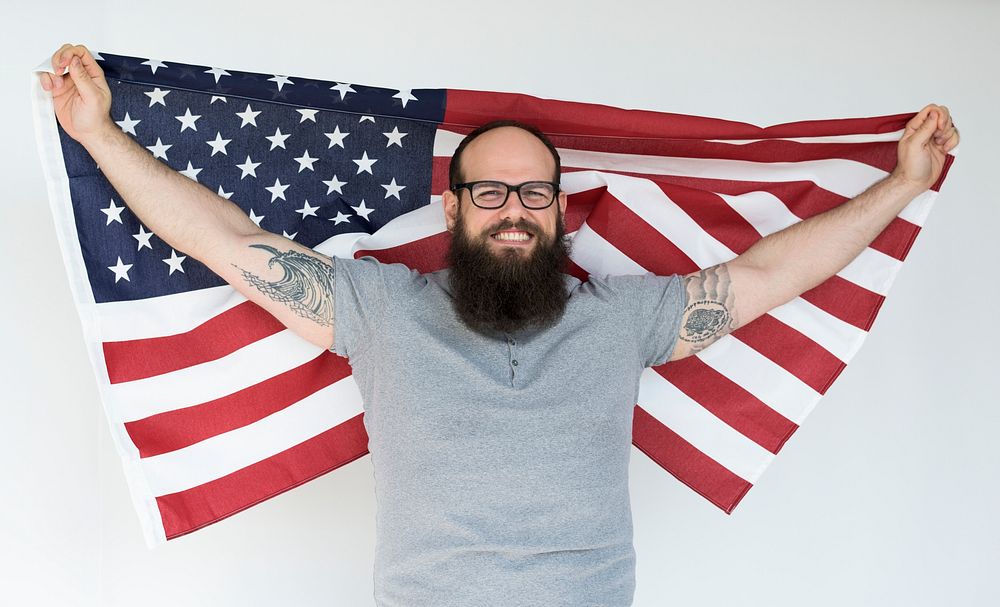 Portrait of a large bearded man with an American flag