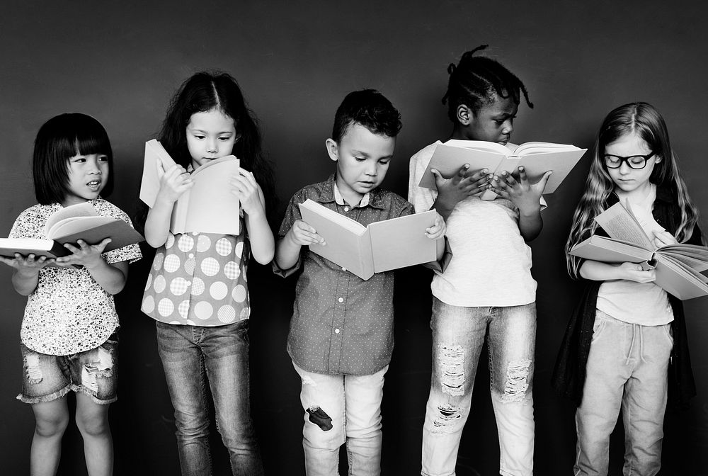 Group of children reading books in class