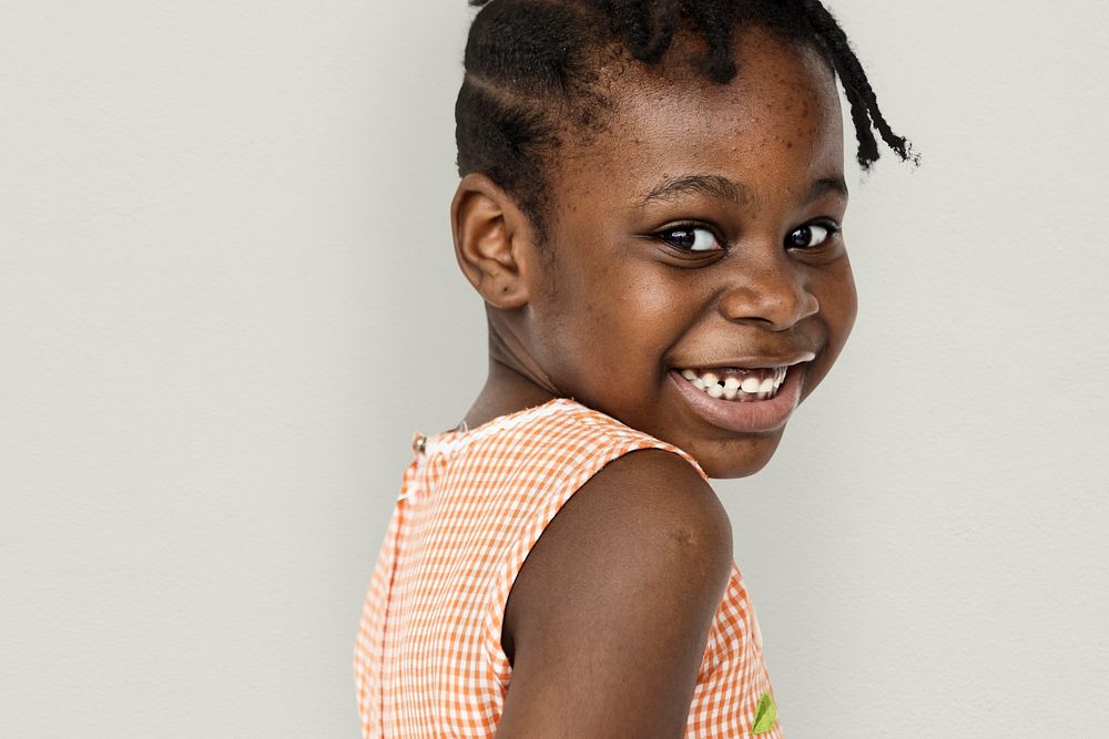 African little girl turn back and smiling studio portrait