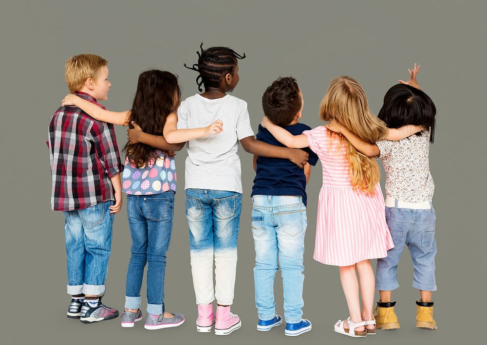 Group of children standing and huddle in rear view