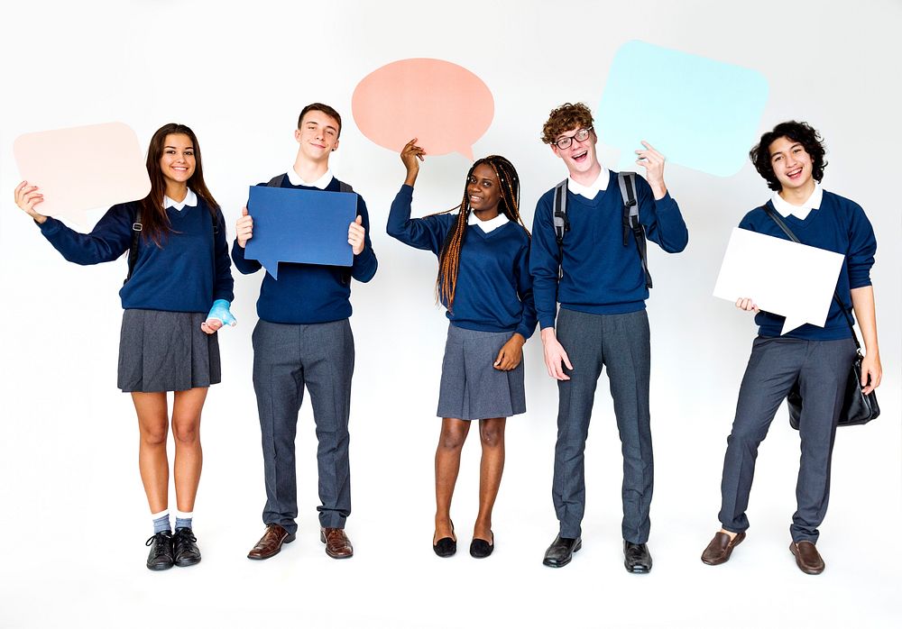Group of students smiling and holding speech bubble