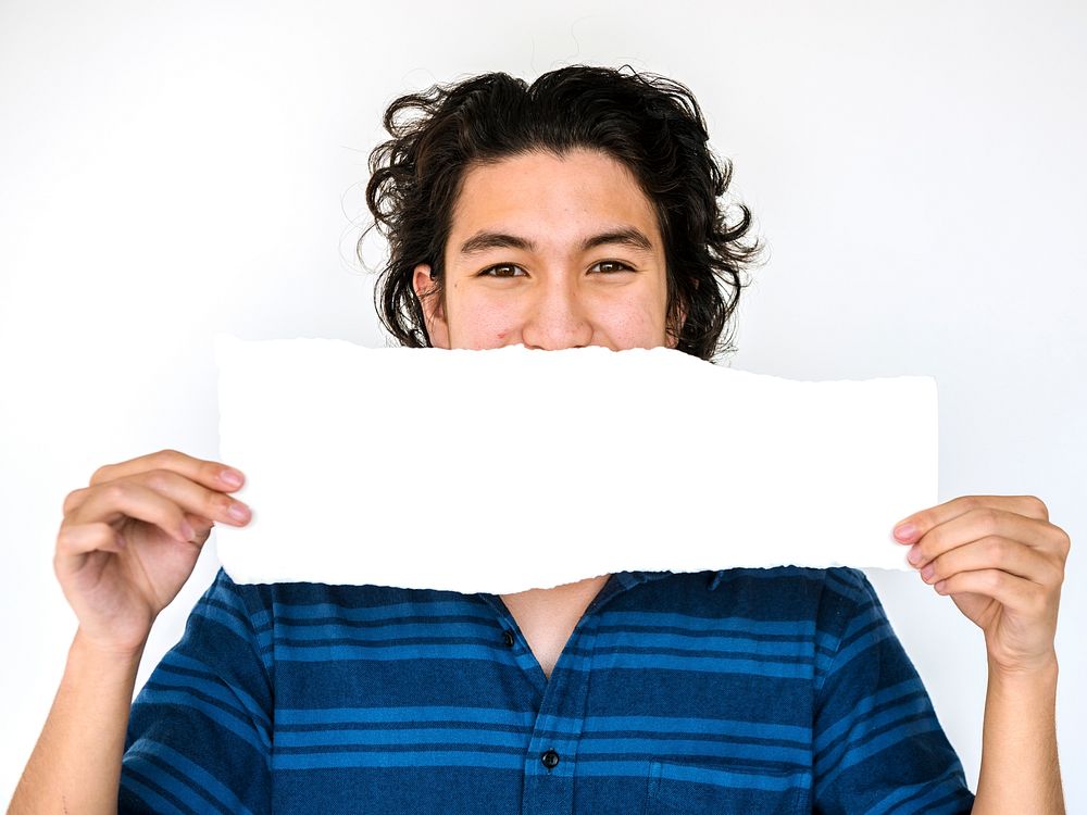 Young man holding empty paper on white background
