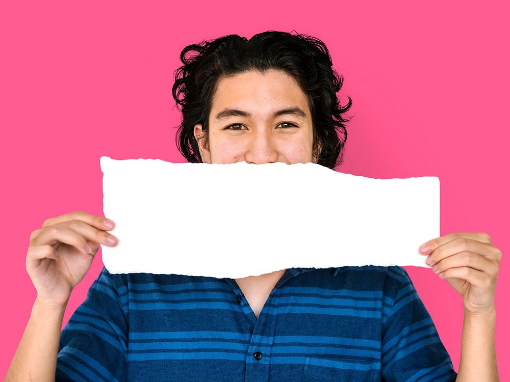 Young adult asian man holding blank paper cover his mouth